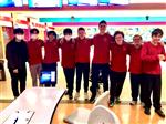 boys bowling team posing at the lanes