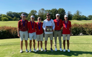 Boys gold team with their region championship plaque