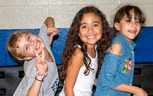  three girls smiling in the gym