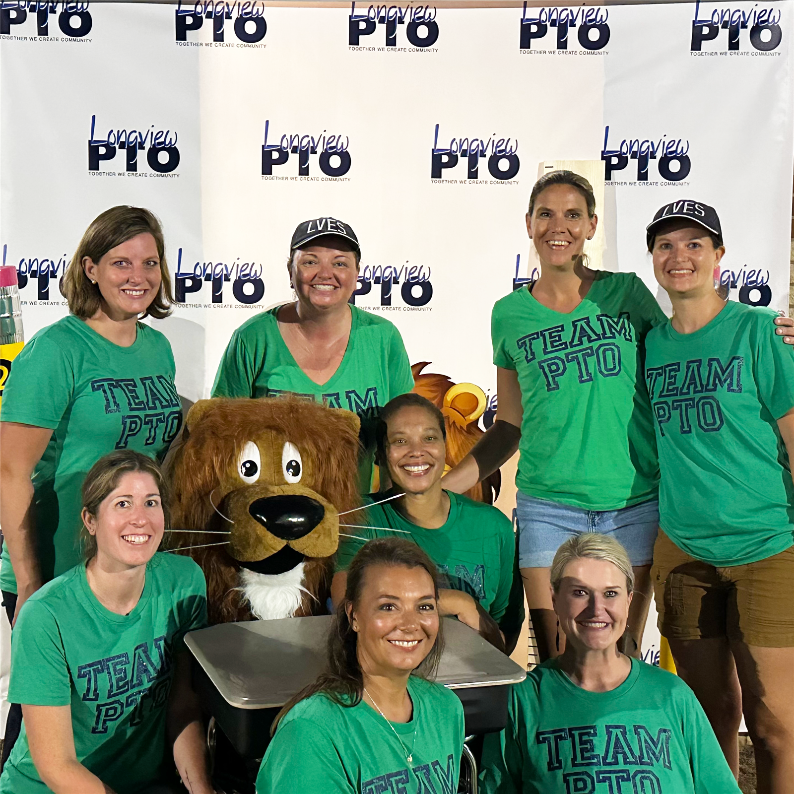 Three PTO Volunteers wearing a green Team PTO tshirt.