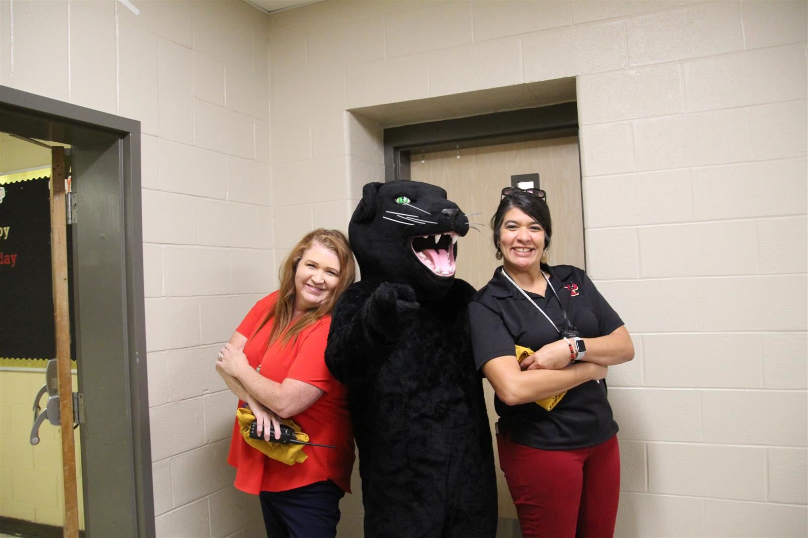  Two principals on either side of a Panther mascot