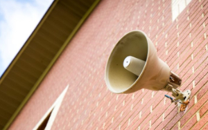  Speaker on outside of a brick building.