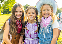  three girls in cowgirl attire