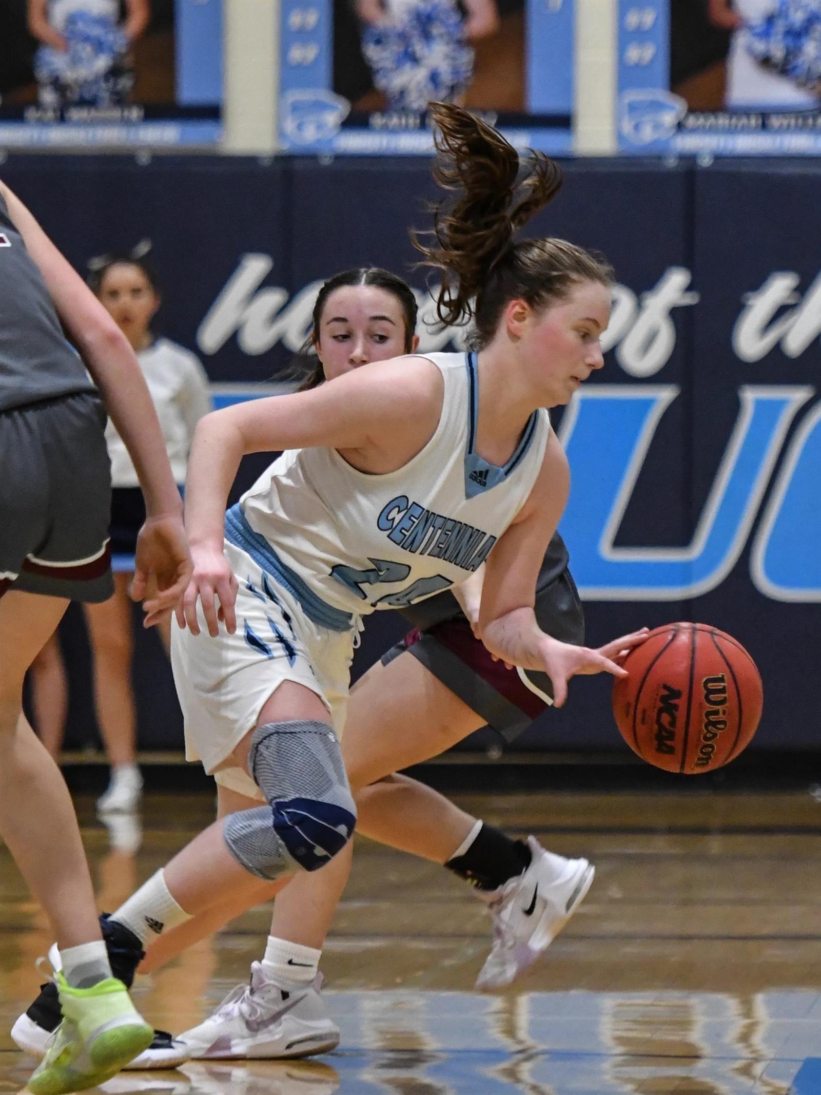 Female basketball player dribbling
