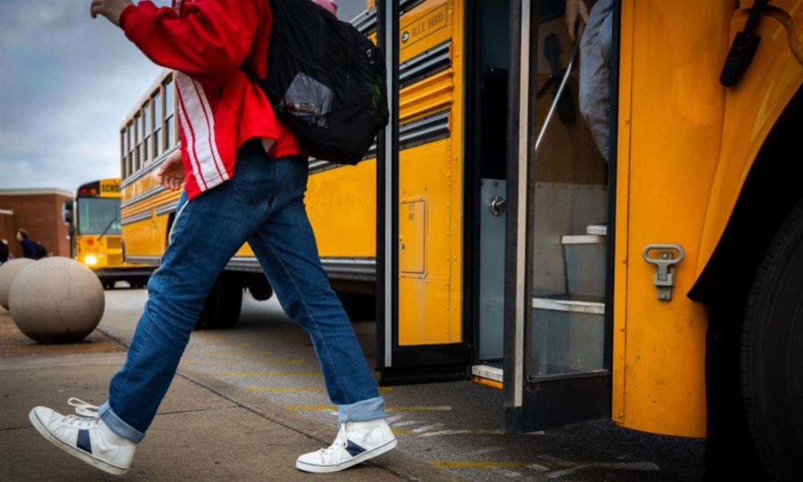 Boy exits bus 
