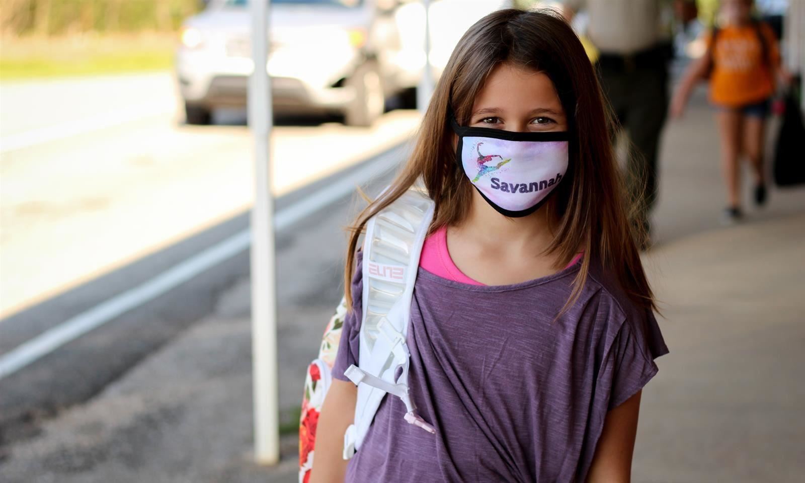 Girl smiles in mask 