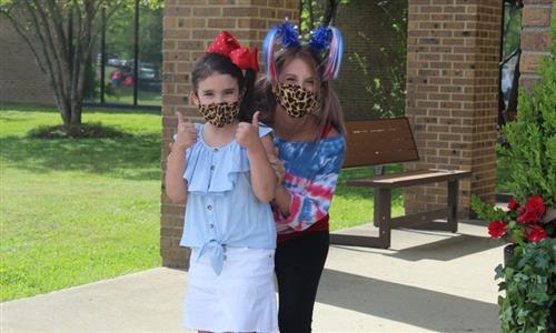A girl and mother wear masks 