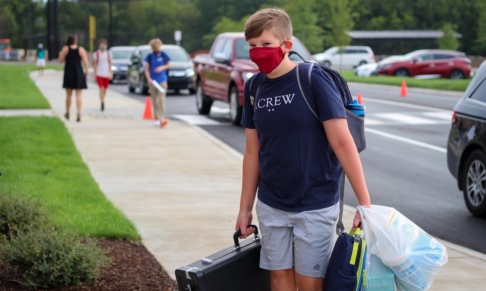 Boy carries bags 