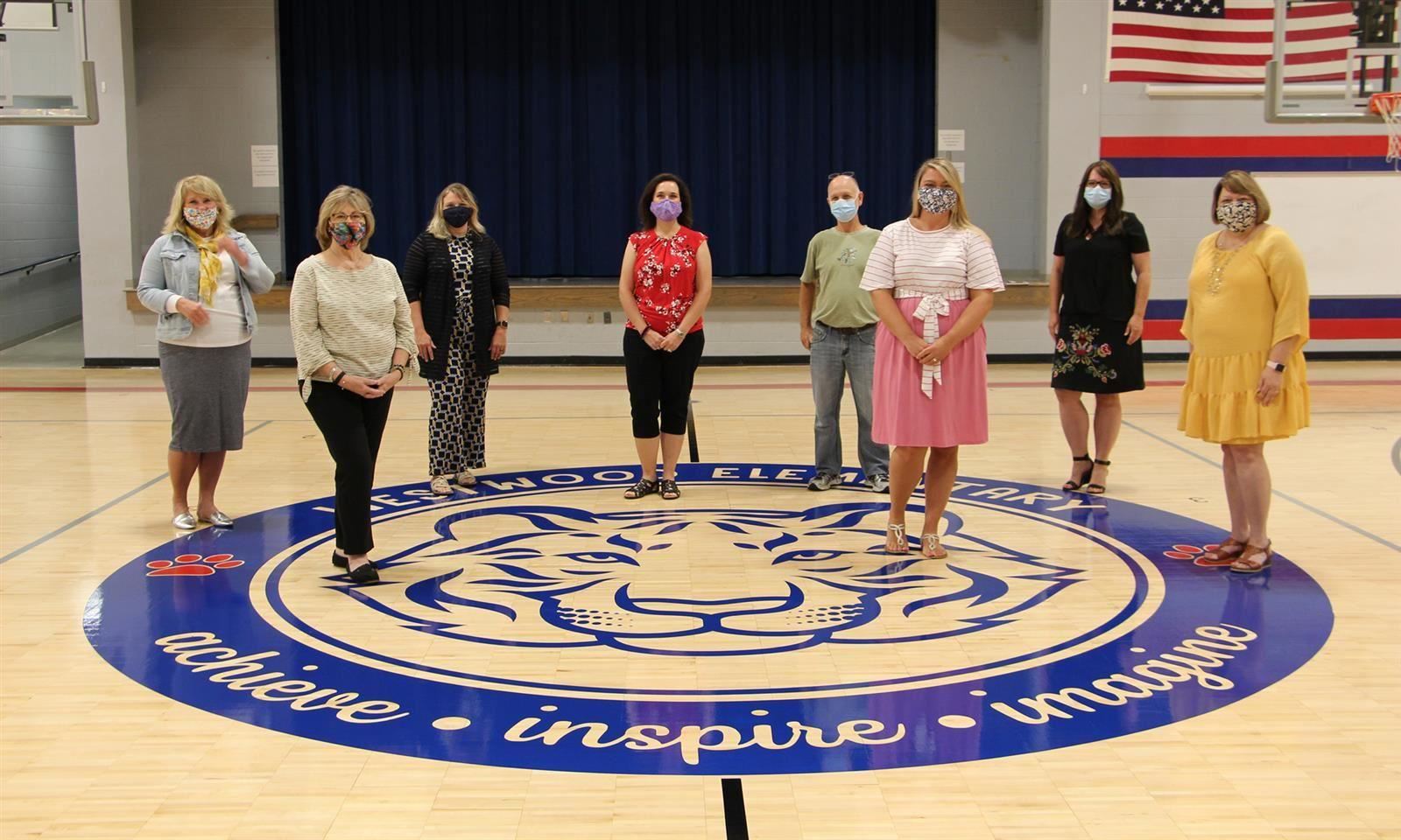 Teachers stand in gym 