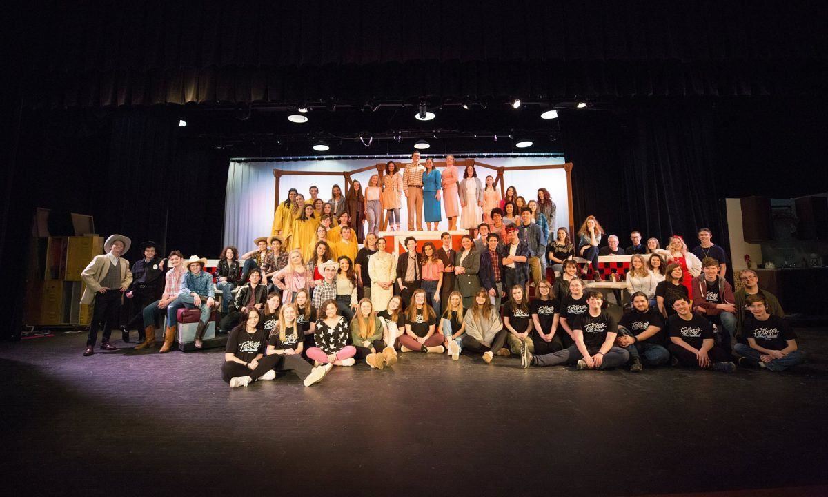 Student Cast poses onstage 
