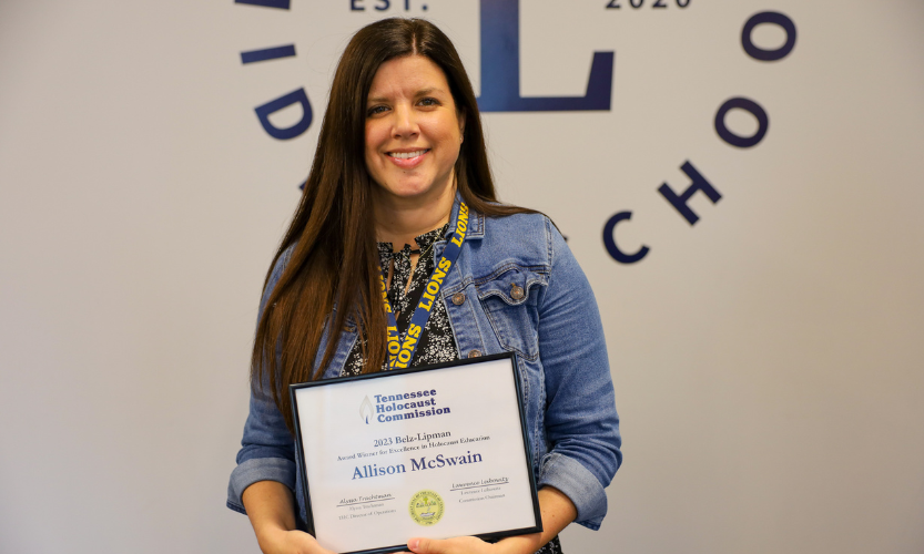 Teacher Allison McSwain holds framed award Teacher Allison McSwain holds framed award