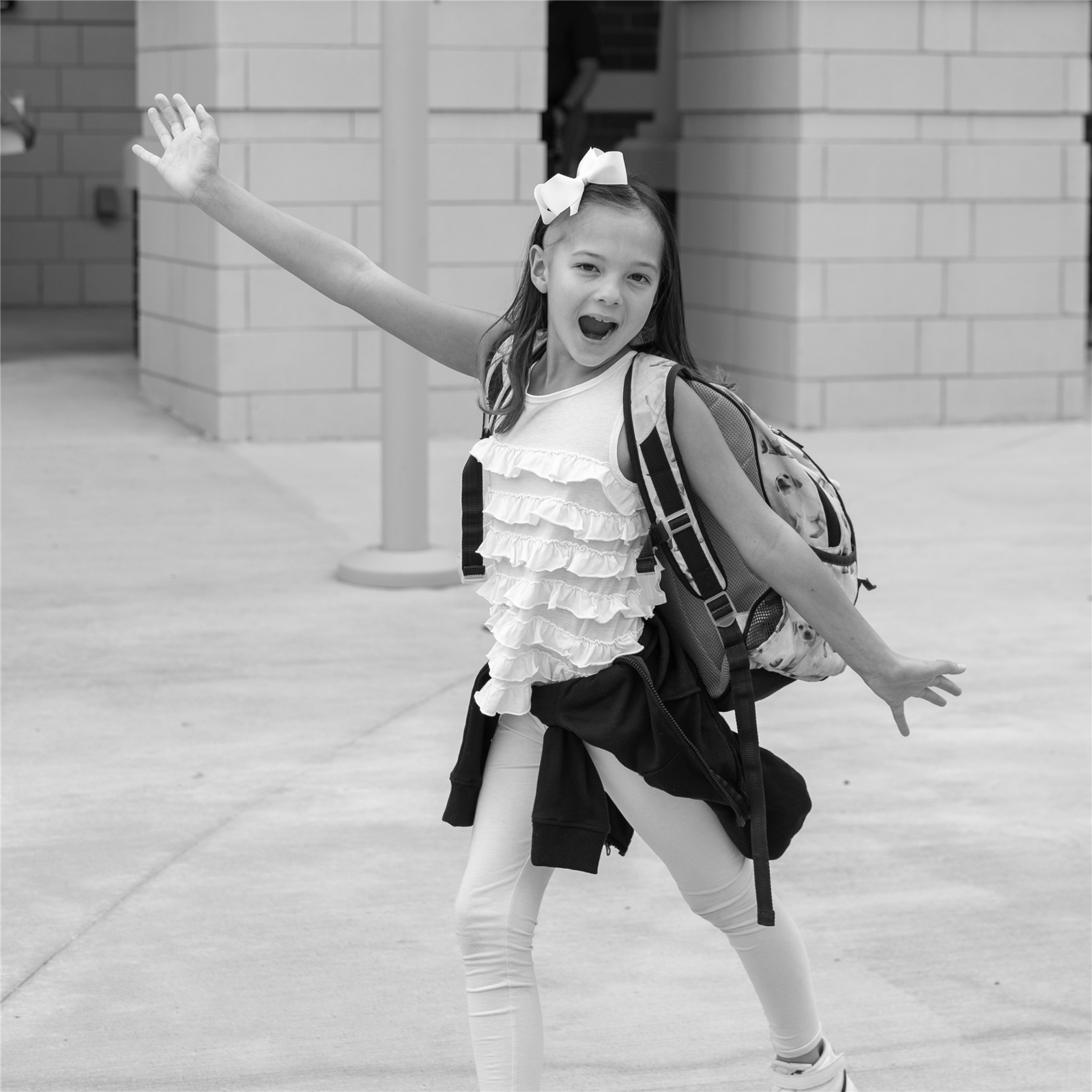 excited girl with arms outstretched to show off ANE