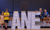  four kids with an ANE sign