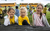  three girls smiling outside
