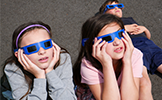 students looking up with eclipse glasses