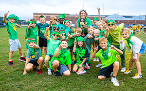  class of students in green shirts
