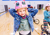  girl smiling in pink cat bike helmet