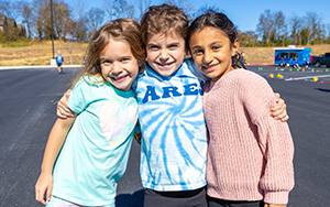  three girls smiling outside