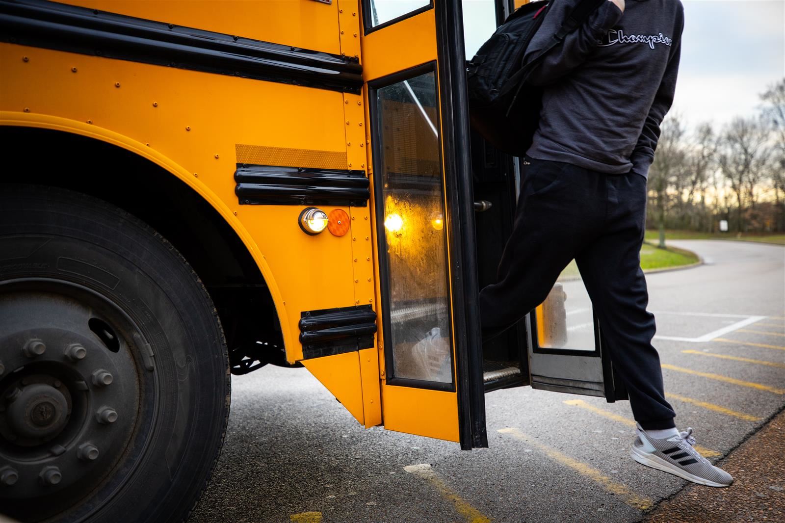 boy stepping off a WCS bus