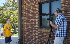  Students being interviewed on camera.