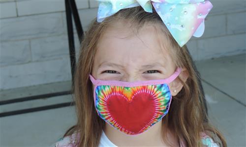 girl in mask smiles 