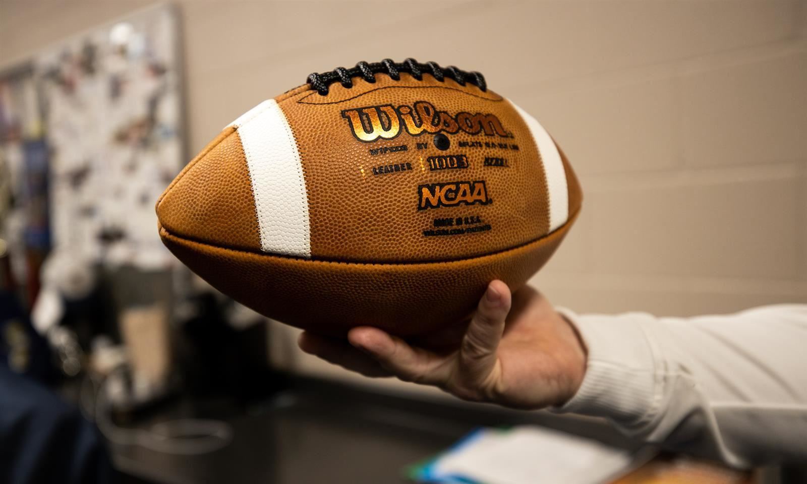Hand holding football 
