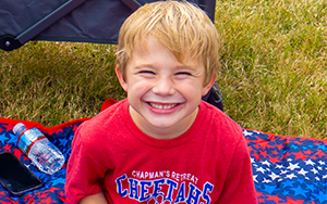  boy smiling in red shirt