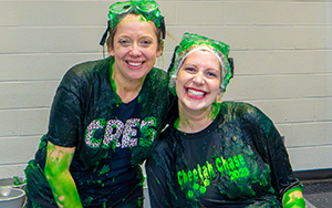  two women covered in green slime