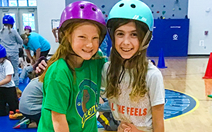  two girls with helmets