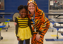  girl and teacher in bee and tiger costume