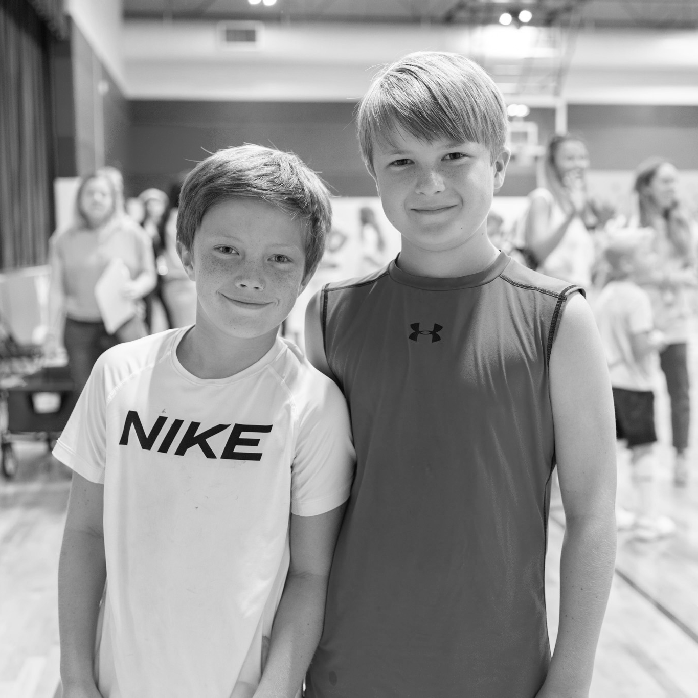 two boys smiling in the gym