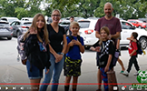  family standing on the sidewalk