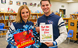  two titans cheerleaders with books in library