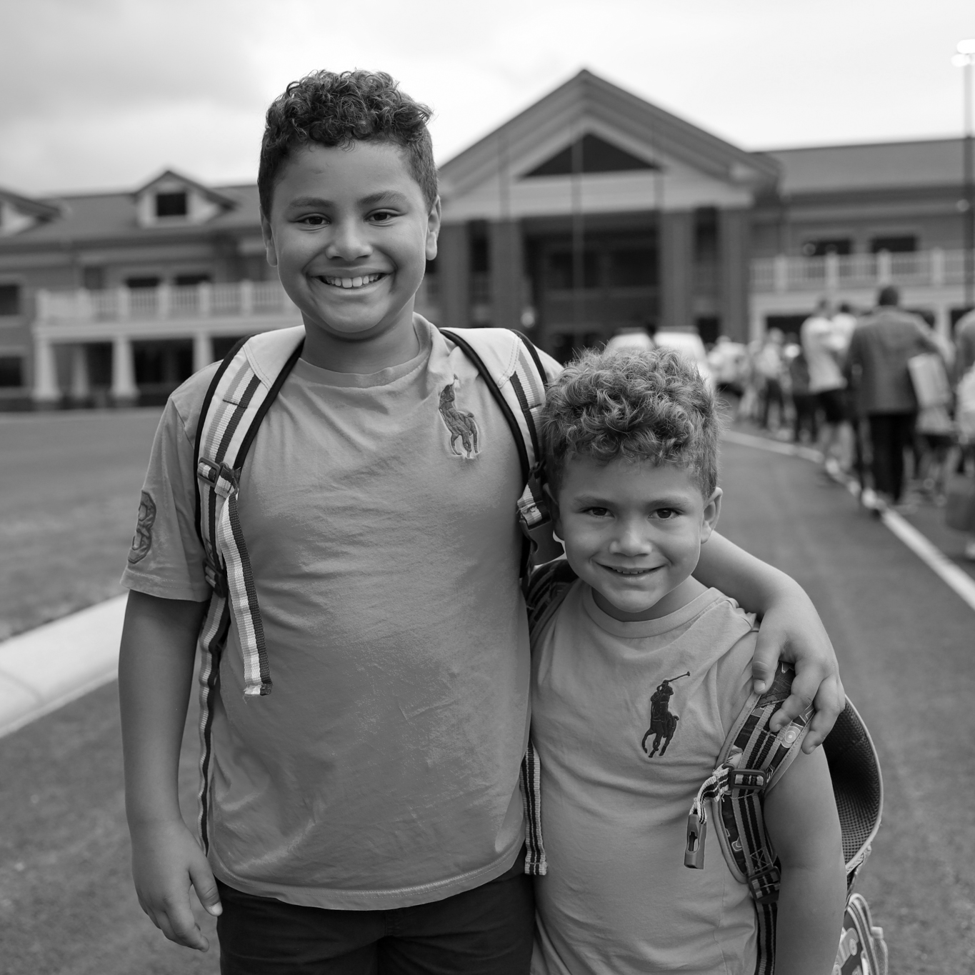 two boys smiling in front of ARES