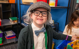  boy in gray wig, hat and glasses