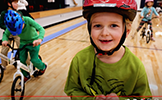  girl in a red helmet and green shirt