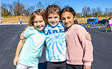  three girls smiling outside