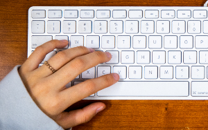  Close-up of students hand on keyboard.