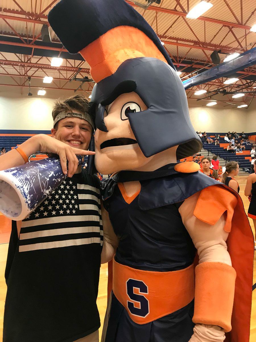 Student and SHS mascot, Sparty, pose for a picture before a pep rally in the gym.