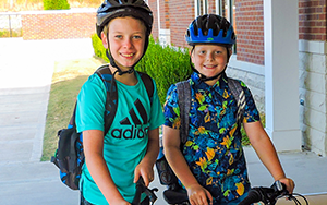  two boys wearing helmets