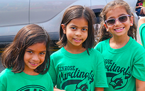  three girls in green shirts