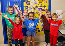  group of students with arms in the air