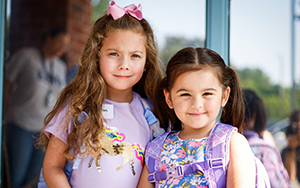 two girls with backpacks 
