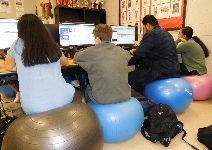  Students coding on stability balls