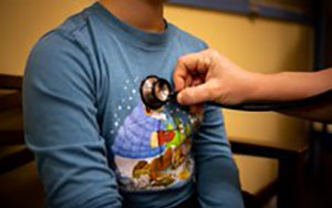  Nurse checking students heart