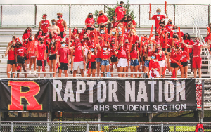 Students wearing red and cheering in the student section