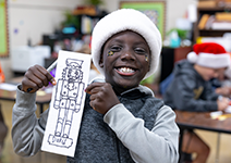  boy smiling with paper nutcracker