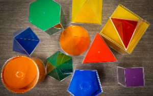 Colorful geometric prisms sit on a table