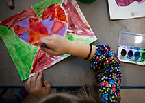  Girl painting with a paint brush.
