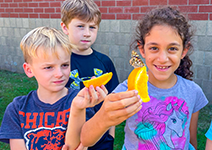  students with oranges and butterflies